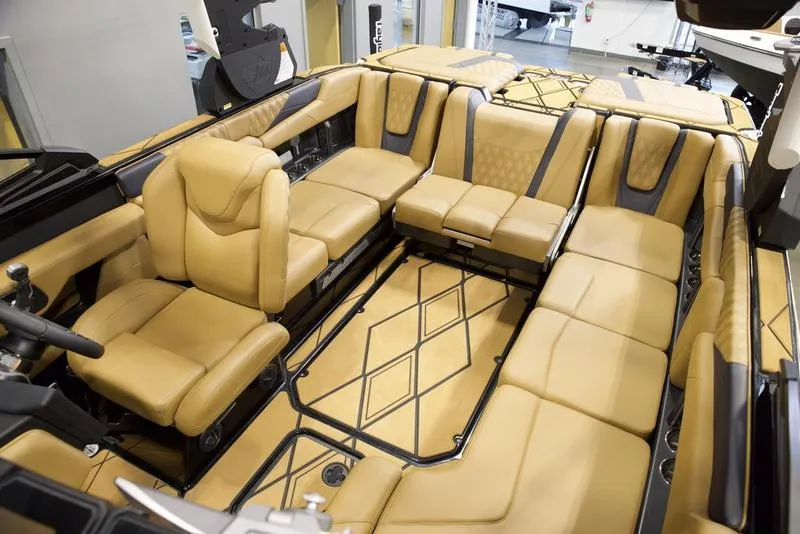 Slide: The Image of Luxurious interior of 2025 Malibu M230 boat with tan leather seating. - 31