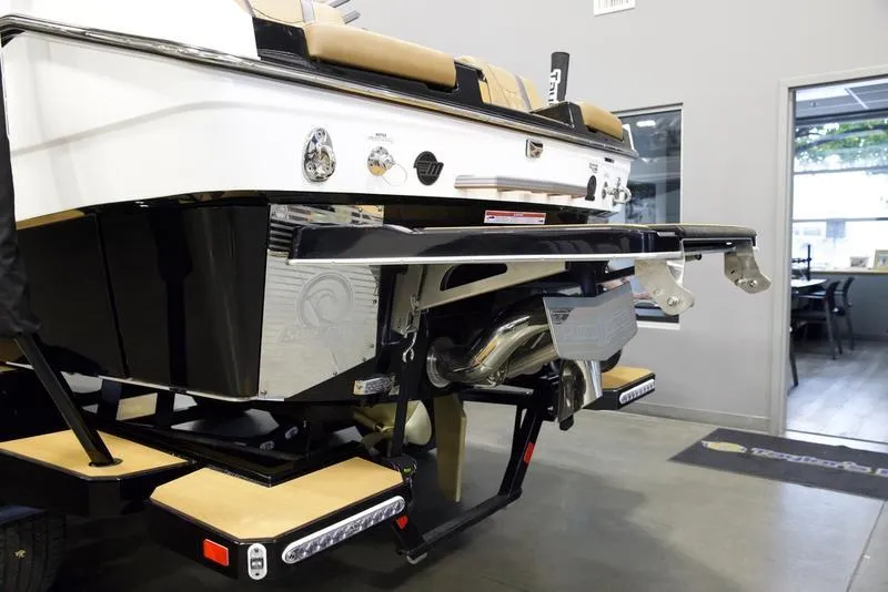 Slide: The Image of 2025 Malibu M230 boat rear view in showroom, showcasing sleek design and advanced features. - 4