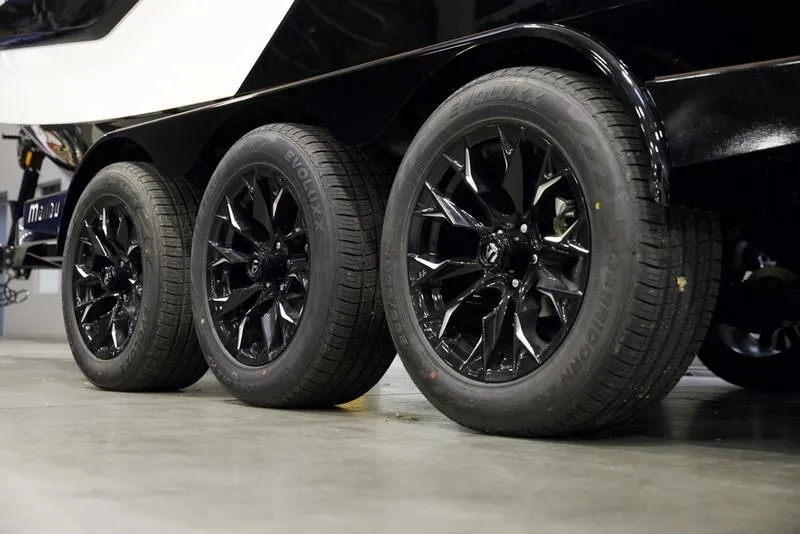 Slide: The Image of 2025 Malibu M230 trailer with sleek black wheels on display. - 8