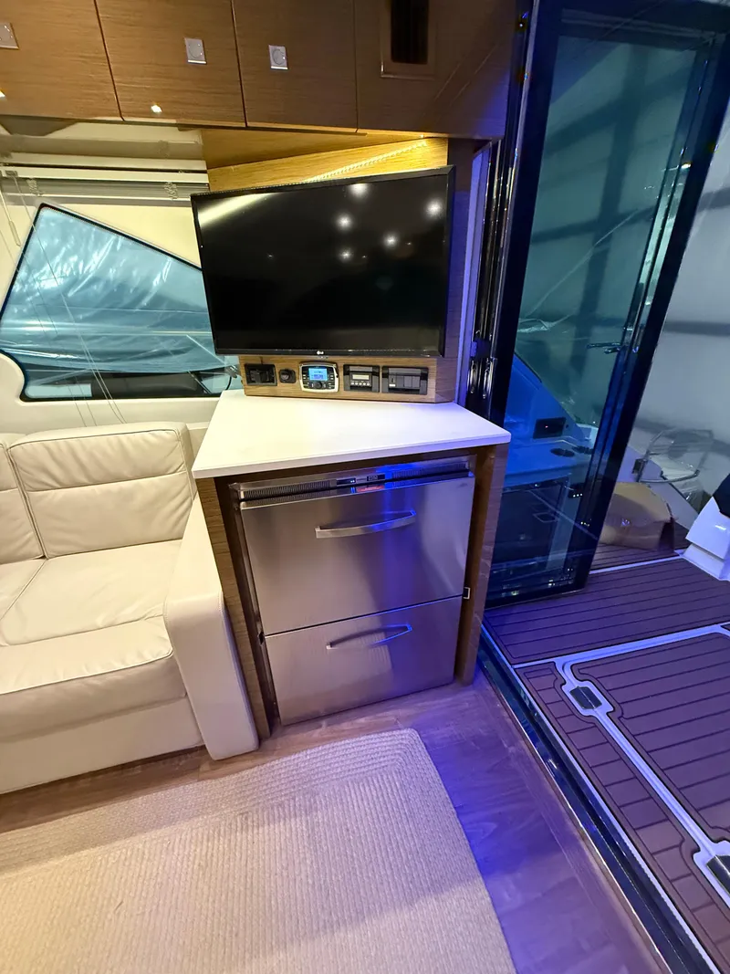 Slide: The Image of Interior of 2018 Cruisers Yachts 50 Cantius with TV, seating, and modern cabinetry. - 11