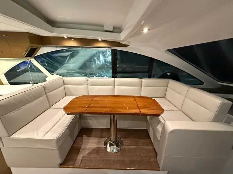 Slide: The Image of Luxurious interior of 2018 Cruisers Yachts 50 Cantius with elegant seating and wooden table. - 14