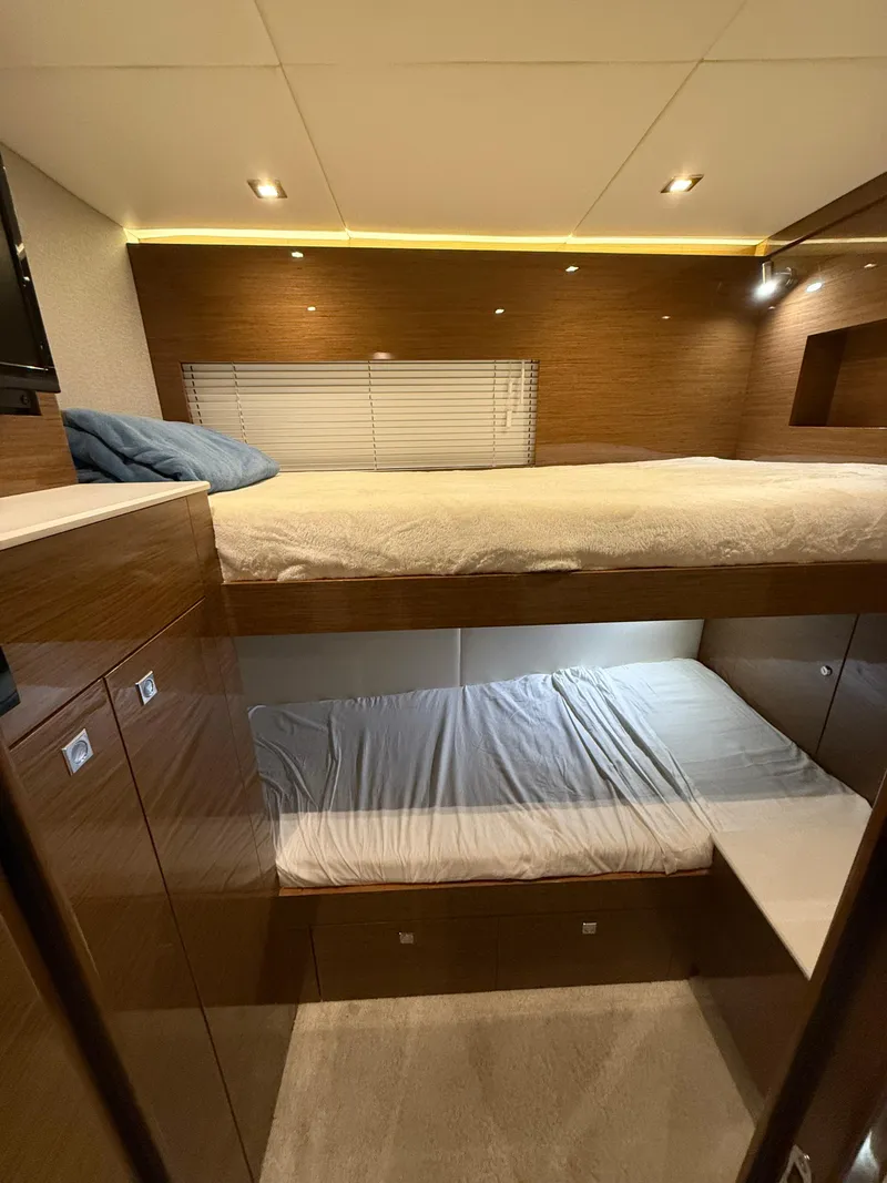 Slide: The Image of 2018 Cruisers Yachts 50 Cantius cabin with cozy bunk beds and modern lighting. - 23