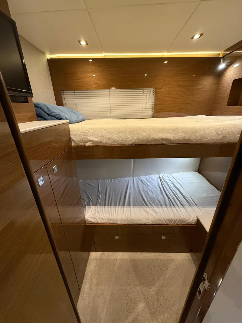 Slide: The Image of 2018 Cruisers Yachts 50 Cantius cabin with bunk beds and modern wood finish. - 26