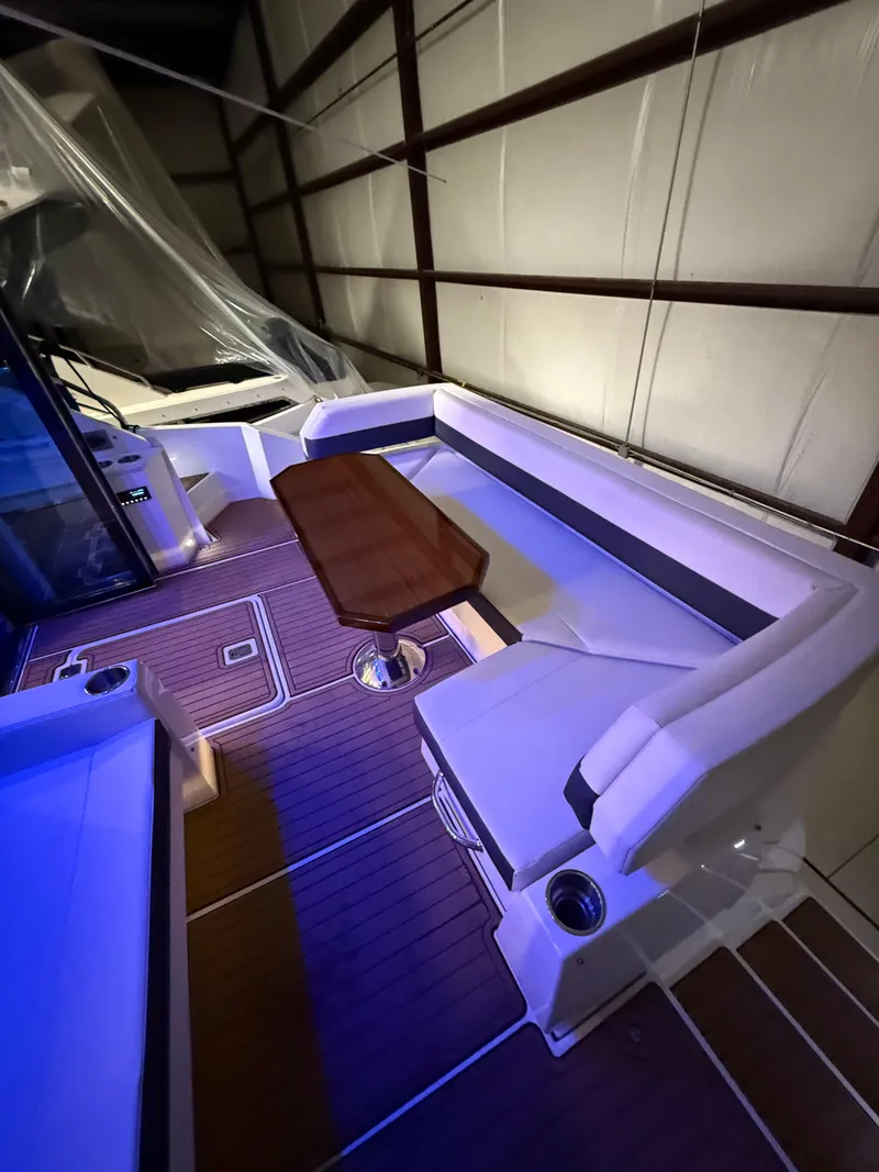 Slide: The Image of 2018 Cruisers Yachts 50 Cantius interior with seating and wooden table in a well-lit cabin. - 5