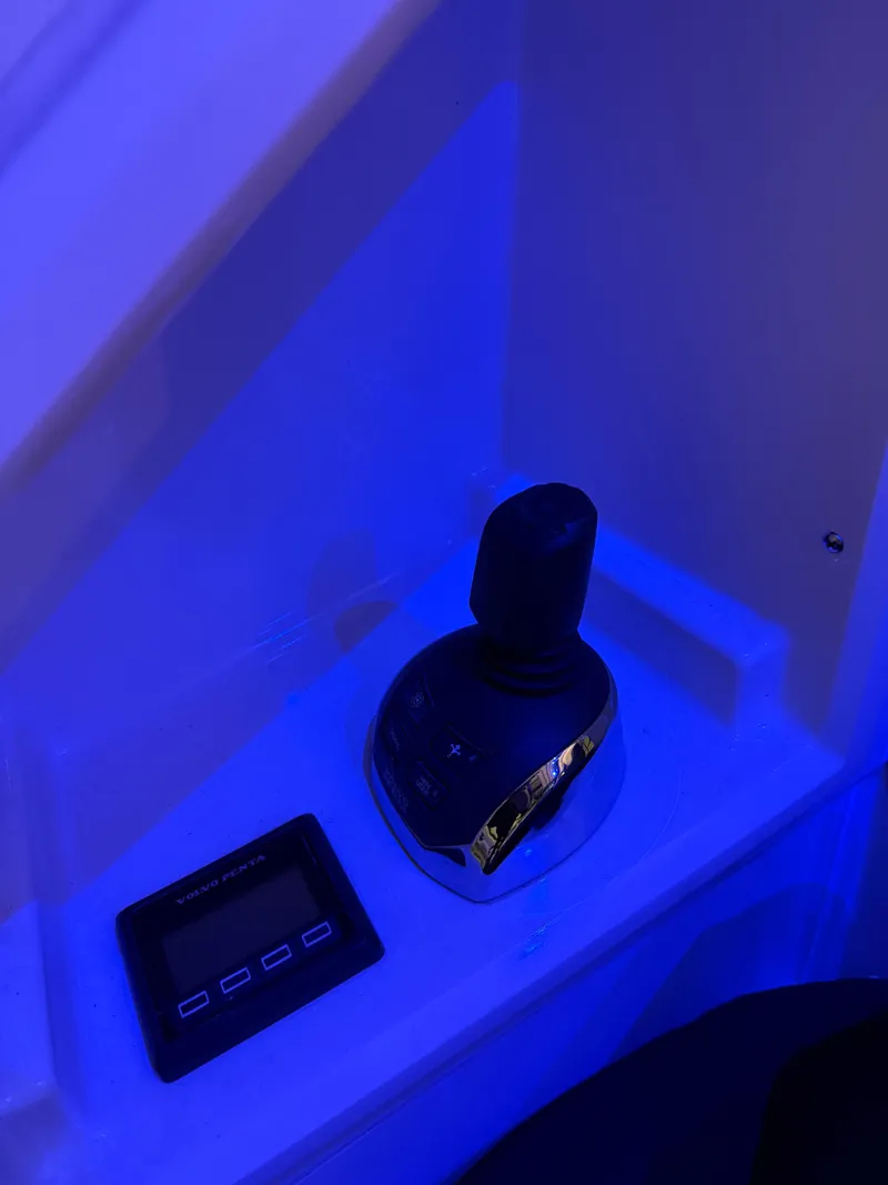 Slide: The Image of Joystick control and display panel on 2018 Cruisers Yachts 50 Cantius, illuminated in blue light. - 7