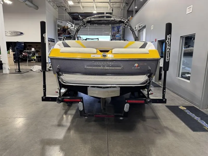 Slide: The Image of 2013 Malibu Wakesetter 24 MXZ boat in showroom, rear view. - 10
