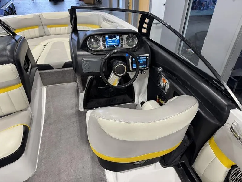 Slide: The Image of 2013 Malibu Wakesetter 24 MXZ interior with modern dashboard and seating. - 11