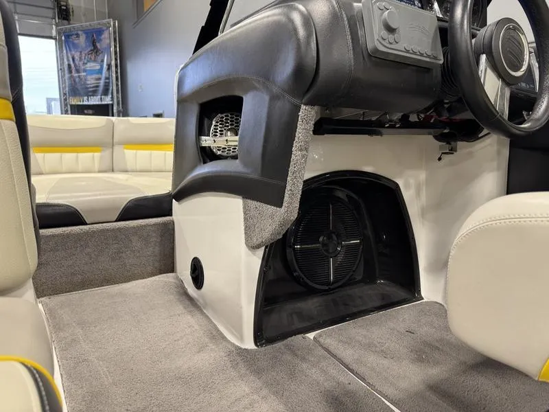 Slide: The Image of 2013 Malibu Wakesetter 24 MXZ interior with seating and dashboard details. - 12