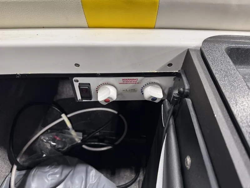 Slide: The Image of 2013 Malibu Wakesetter 24 MXZ control panel with knobs and wiring. - 15