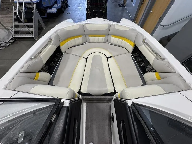 Slide: The Image of 2013 Malibu Wakesetter 24 MXZ boat interior with white and yellow seating. - 18