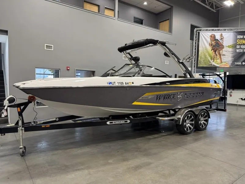 Slide: The Image of 2013 Malibu Wakesetter 24 MXZ boat on trailer in showroom. - 3