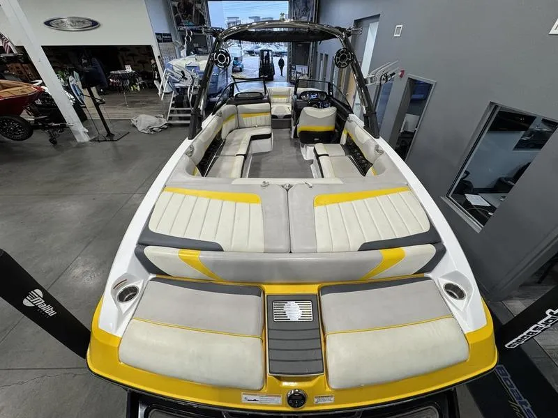 Slide: The Image of 2013 Malibu Wakesetter 24 MXZ boat with yellow and gray interior in showroom. - 7