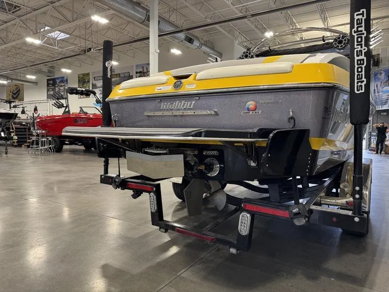 Slide: The Image of 2013 Malibu Wakesetter 24 MXZ boat in showroom, rear view. - 8