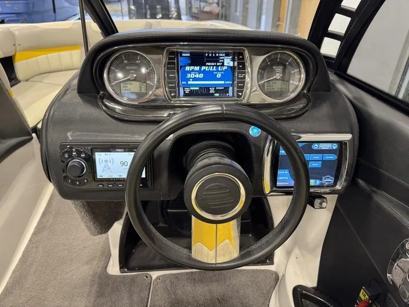 Slide: The Image of 2013 Malibu Wakesetter 24 MXZ dashboard with steering wheel and digital displays. - 9