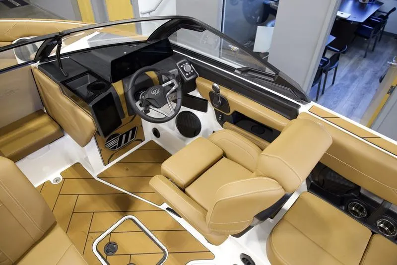 Slide: The Image of 2025 Malibu 23 LSV boat interior with tan leather seats and modern dashboard. - 10