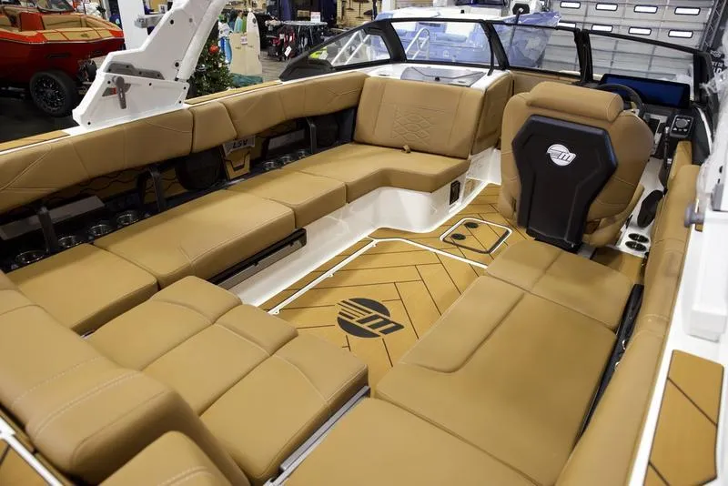 Slide: The Image of Luxurious interior of 2025 Malibu 23 LSV boat with tan seating and modern design. - 16