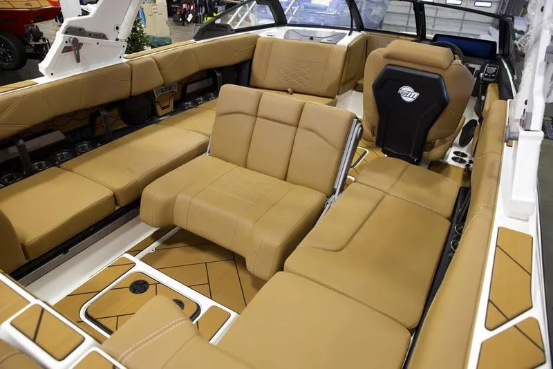 Slide: The Image of 2025 Malibu 23 LSV boat interior with luxurious tan seating and modern design. - 17