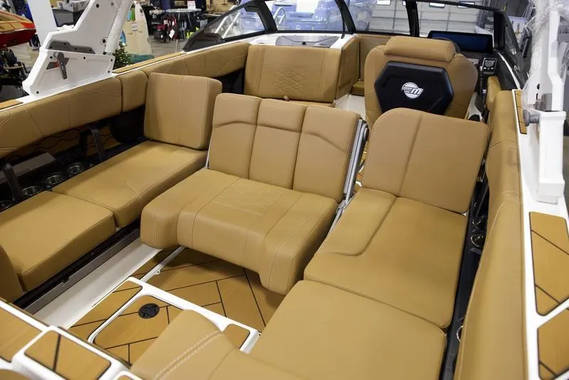 Slide: The Image of 2025 Malibu 23 LSV boat interior with tan leather seating and modern design. - 18