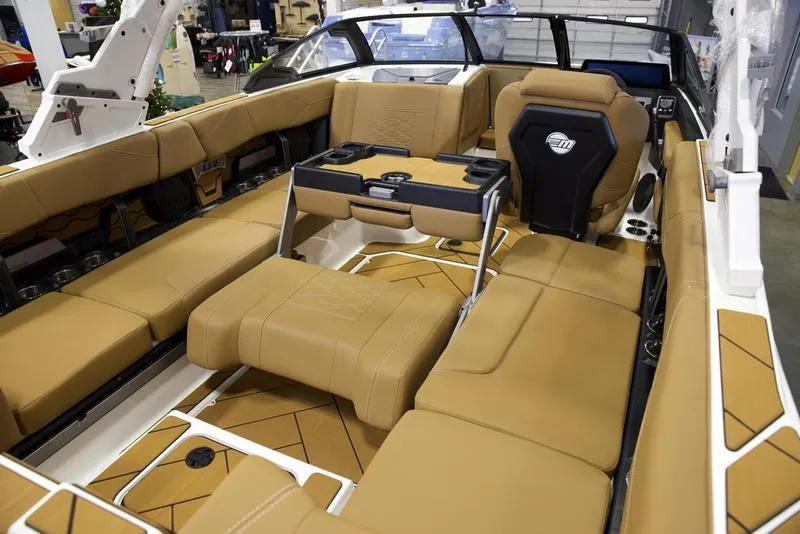 Slide: The Image of 2025 Malibu 23 LSV boat interior with tan leather seating and modern design. - 19