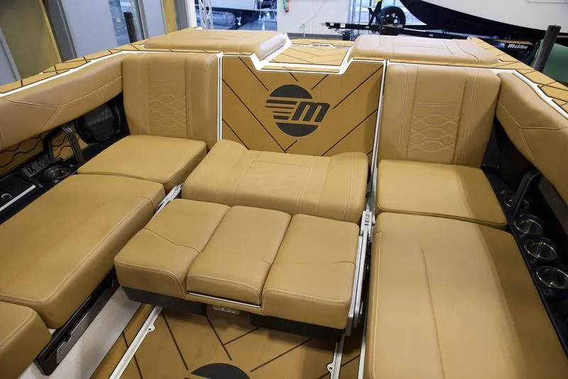 Slide: The Image of 2025 Malibu 23 LSV boat interior with tan leather seating and modern design. - 20