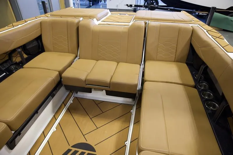 Slide: The Image of Luxurious interior of 2025 Malibu 23 LSV boat with tan leather seating. - 21