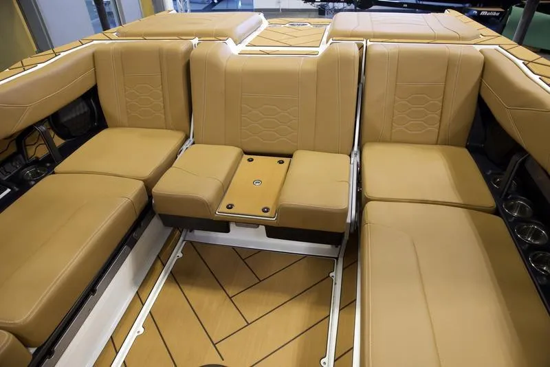 Slide: The Image of Luxurious tan seating in 2025 Malibu 23 LSV boat interior. - 22