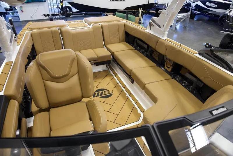 Slide: The Image of Luxurious interior of 2025 Malibu 23 LSV boat with tan leather seating. - 23