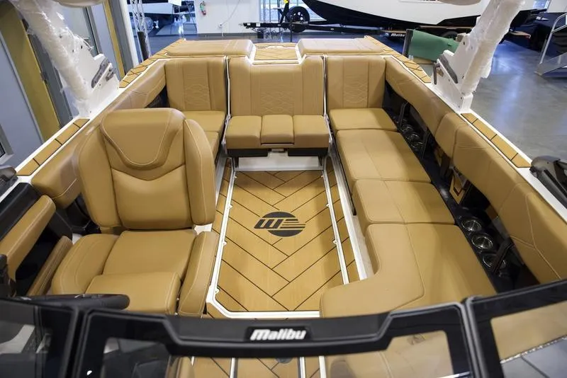 Slide: The Image of Luxurious interior of 2025 Malibu 23 LSV boat with tan leather seating. - 24