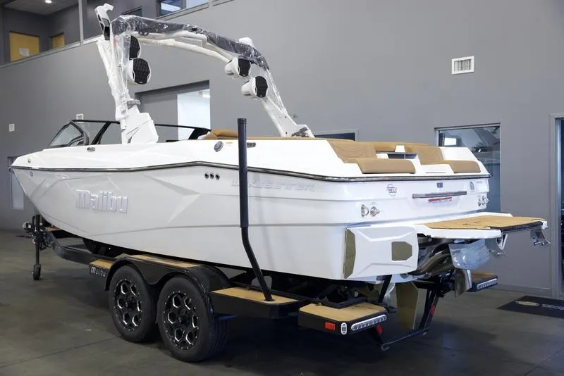 Slide: The Image of 2025 Malibu 23 LSV boat on trailer in showroom, rear view. - 4