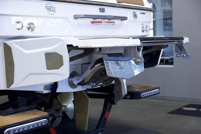 Slide: The Image of 2025 Malibu 23 LSV boat rear view with propeller and exhaust details. - 5