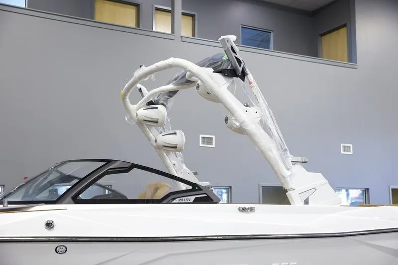 Slide: The Image of 2025 Malibu 23 LSV boat with sleek design and advanced wakeboard tower. - 7