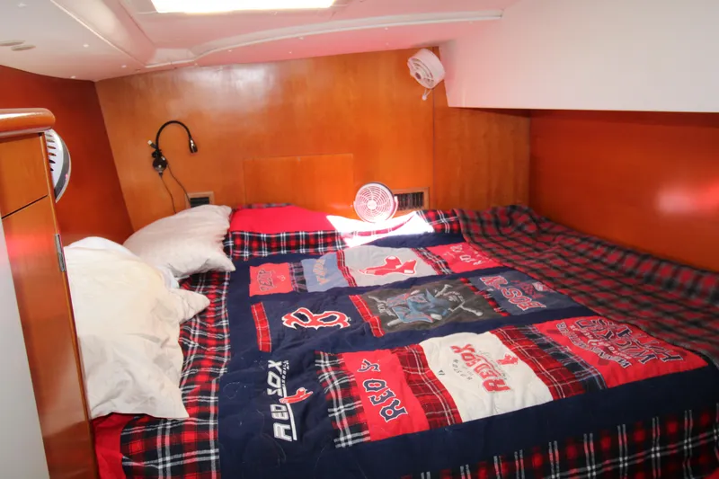 Slide: The Image of Cozy cabin interior of 2002 Lagoon 410 with Red Sox-themed bedding. - 22