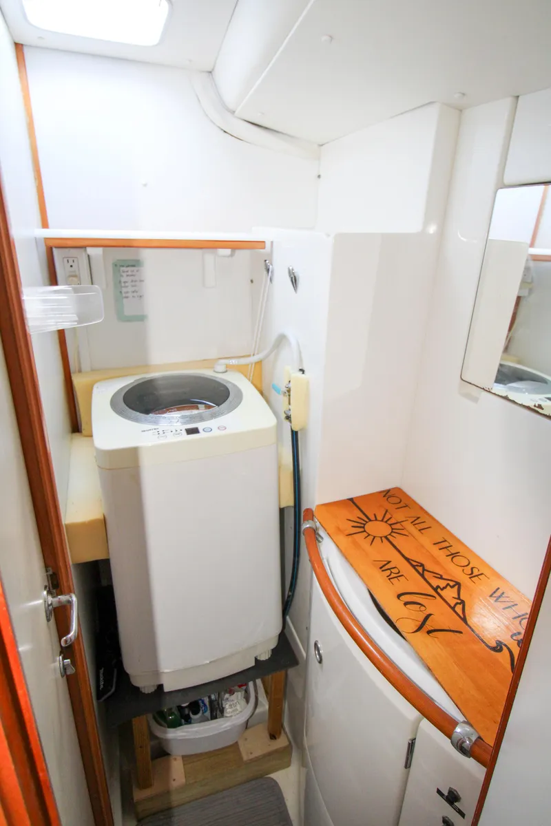 Slide: The Image of Laundry area in 2002 Lagoon 410 yacht with washing machine and storage. - 23