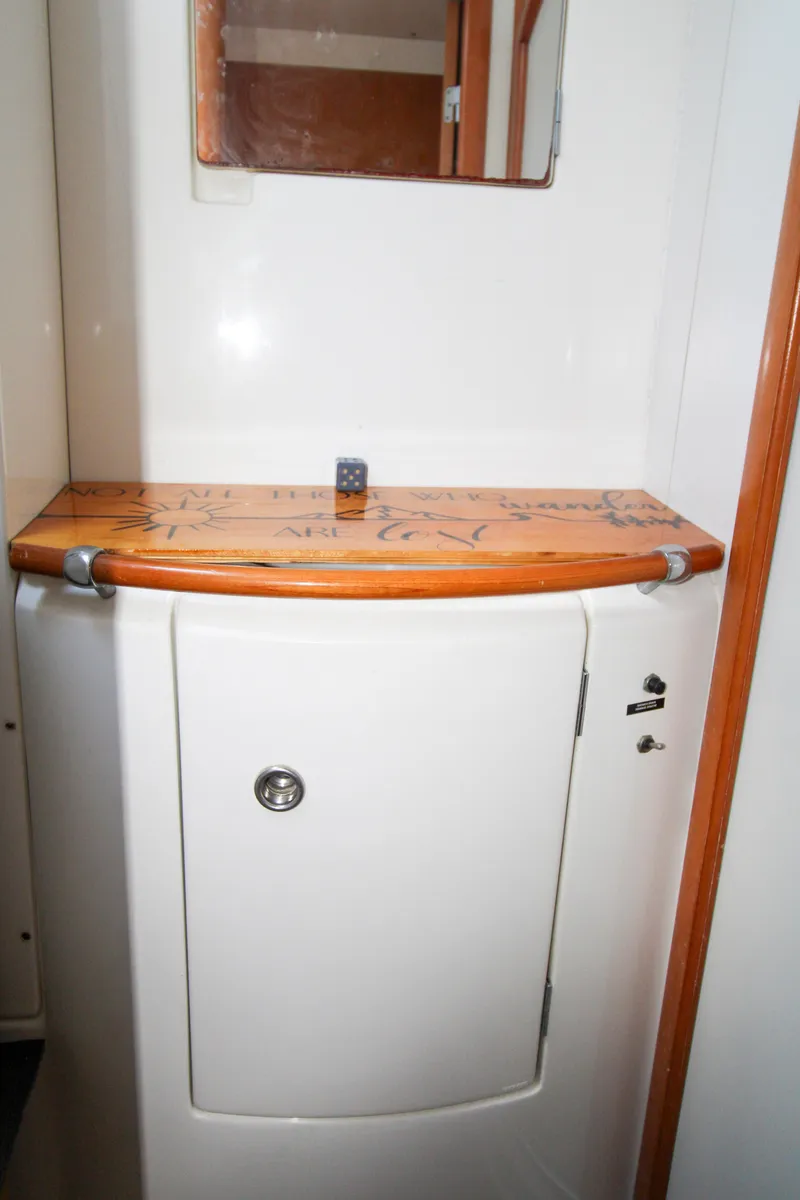 Slide: The Image of Lagoon 410 2002 yacht bathroom with wooden countertop and mirror. - 25