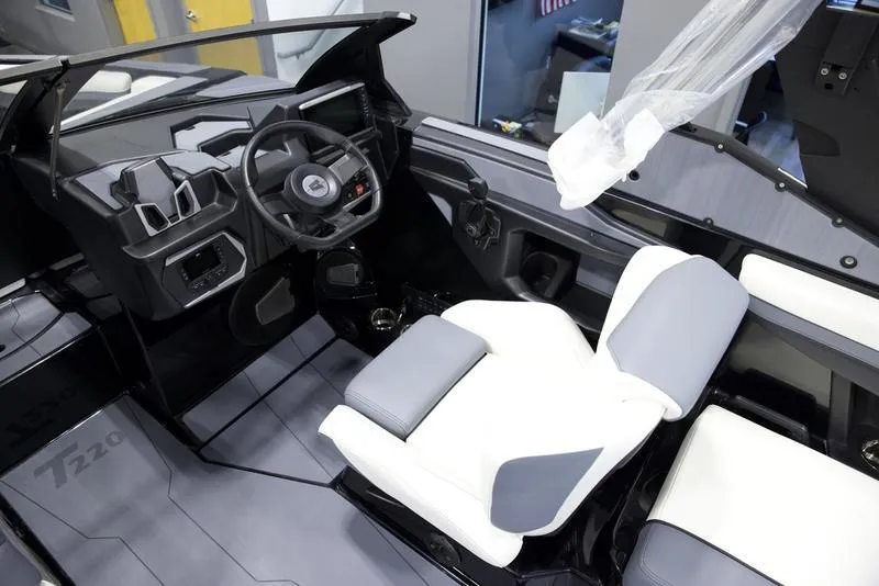Slide: The Image of 2025 Axis T220 boat interior with modern steering and seating design. - 11