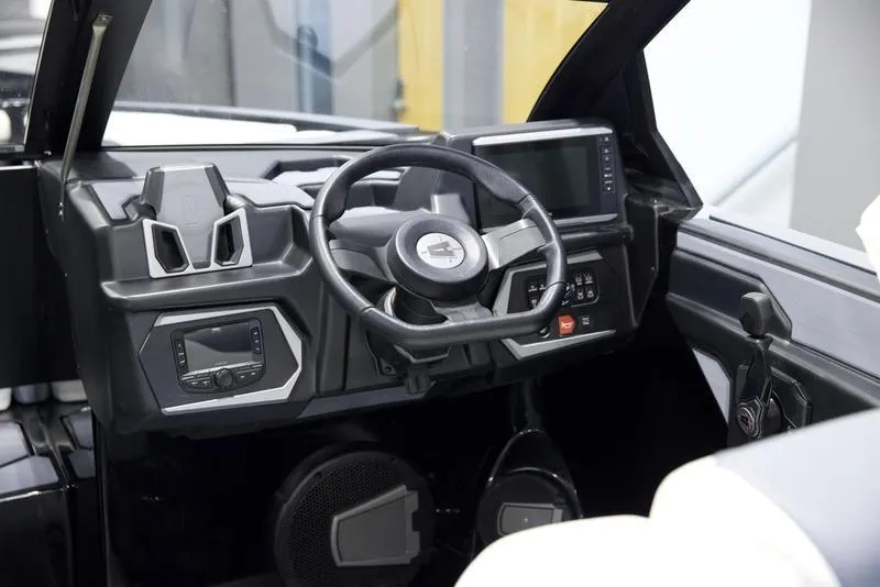 Slide: The Image of 2025 Axis T220 boat dashboard with modern steering wheel and digital controls. - 13