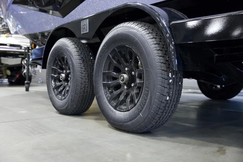 Slide: The Image of 2025 Axis T220 trailer with dual black wheels on display. - 6