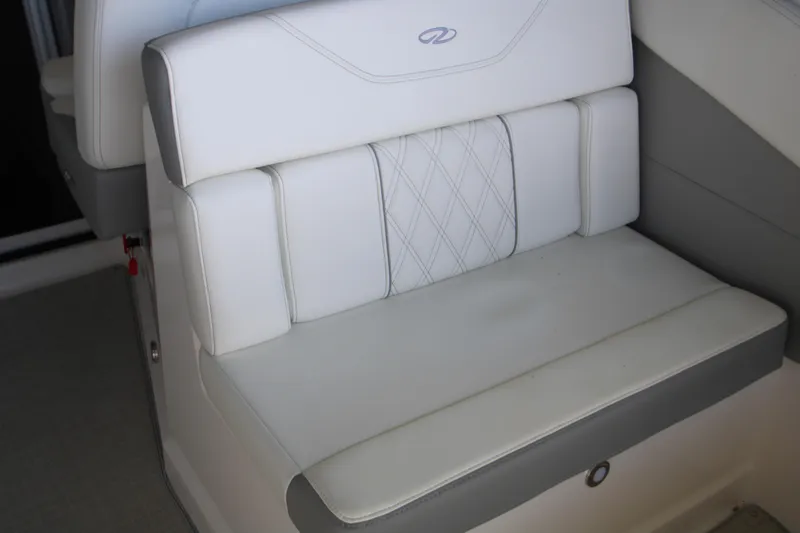 Slide: The Image of 2022 Regal 28 Express boat seat with white and gray upholstery. - 14