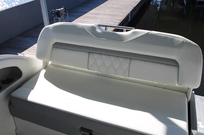 Slide: The Image of 2022 Regal 28 Express boat seat with white upholstery and diamond pattern. - 17