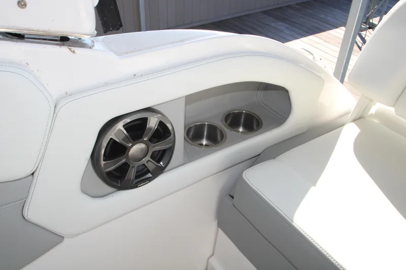 Slide: The Image of 2022 Regal 28 Express boat interior with speaker and cup holders. - 18