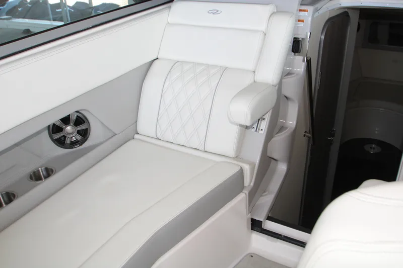 Slide: The Image of 2022 Regal 28 Express boat interior with white seating and cabin entrance. - 21
