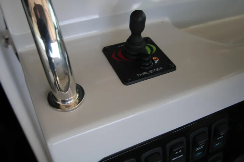 Slide: The Image of 2022 Regal 28 Express boat control panel with joystick thruster. - 25