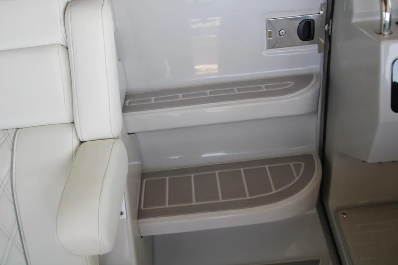Slide: The Image of Interior steps of 2022 Regal 28 Express boat, featuring sleek design and white upholstery. - 26