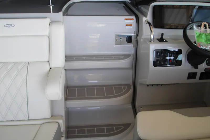 Slide: The Image of Interior of 2022 Regal 28 Express boat with seating and control panel. - 27