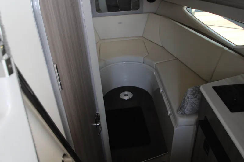 Slide: The Image of Interior cabin of 2022 Regal 28 Express boat with seating and window. - 28