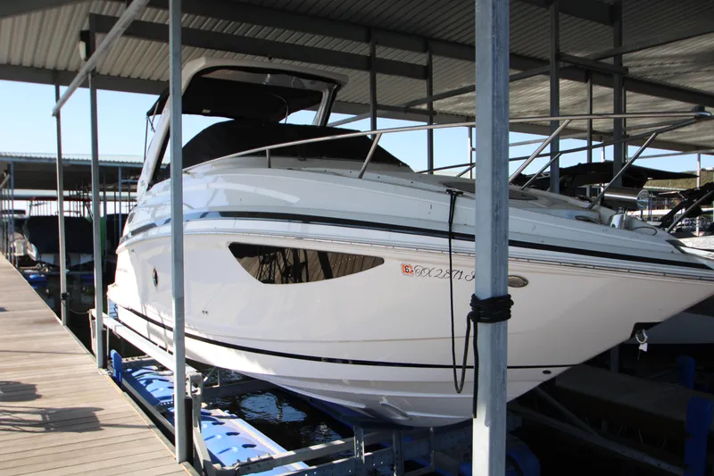 Slide: The Image of 2022 Regal 28 Express boat docked under a covered marina. - 3