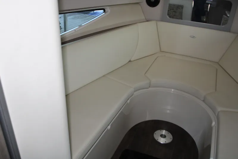 Slide: The Image of Interior seating area of 2022 Regal 28 Express boat, featuring cream upholstery. - 30