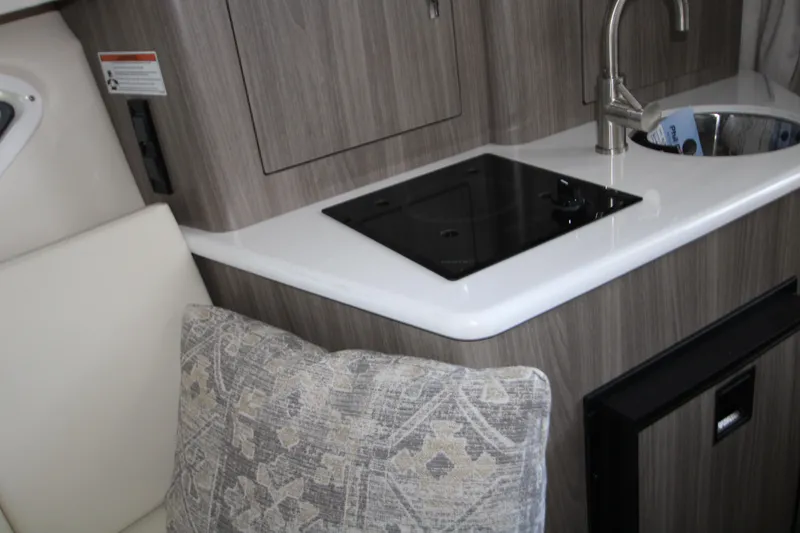 Slide: The Image of 2022 Regal 28 Express boat interior with kitchenette and sink. - 33