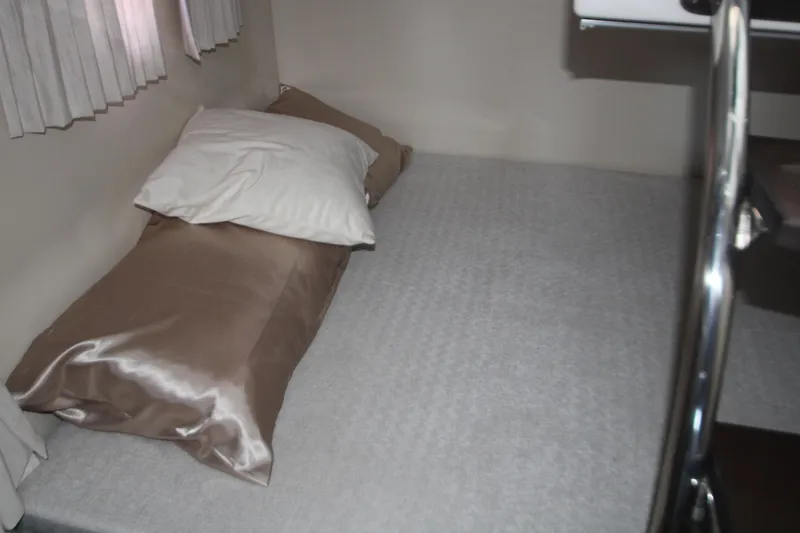 Slide: The Image of 2022 Regal 28 Express cabin interior with bed and pillows. - 34
