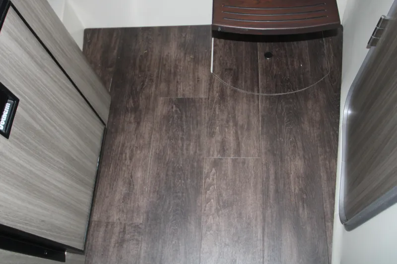 Slide: The Image of 2022 Regal 28 Express interior with wood flooring and compact design. - 39